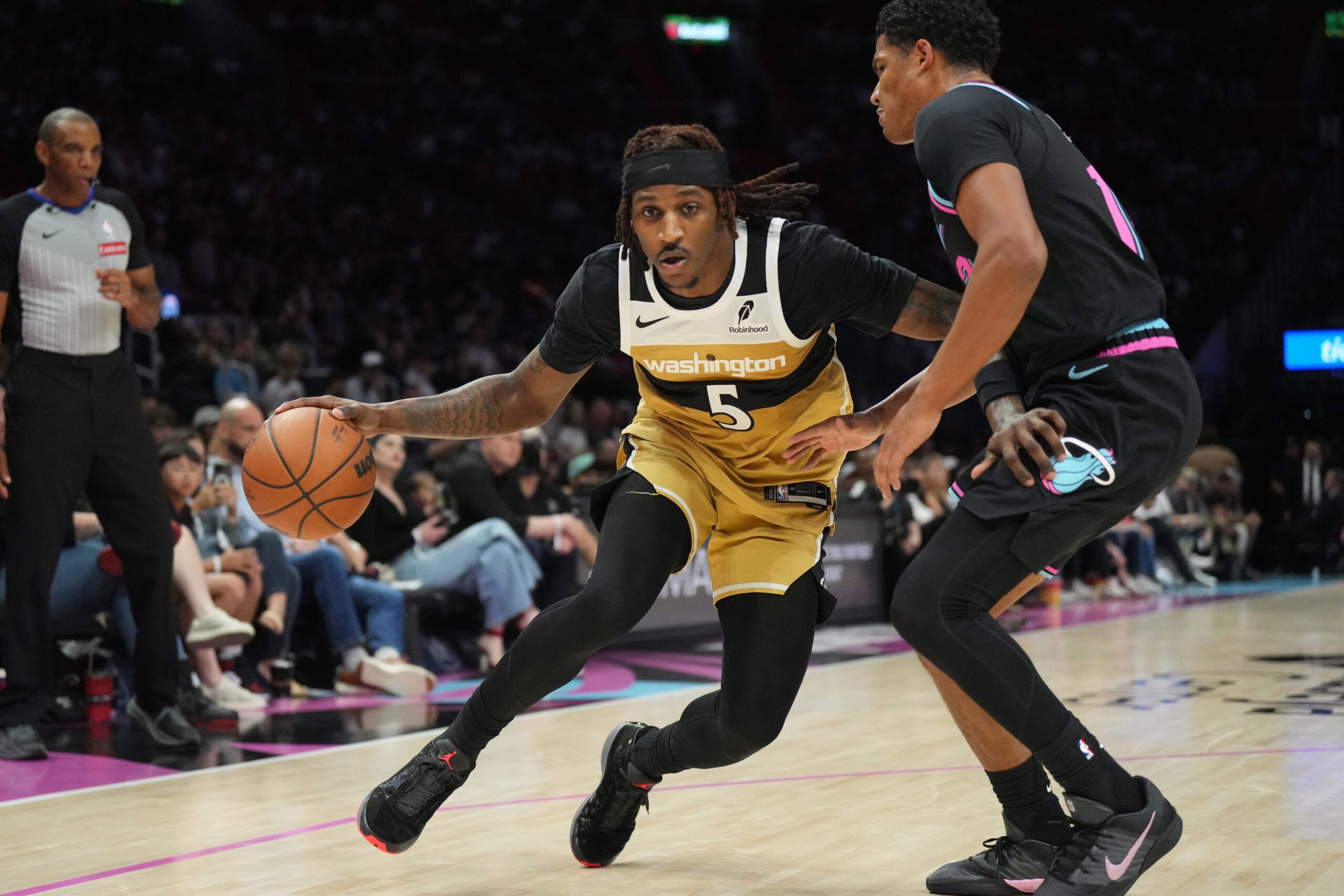 Apr 4, 2026; Miami, Florida, USA;  Washington Wizards guard Jamir Watkins (5) drives past Miami Heat guard Dru Smith (12) during the second half at Kaseya Center. Mandatory Credit: Jim Rassol-Imagn Images