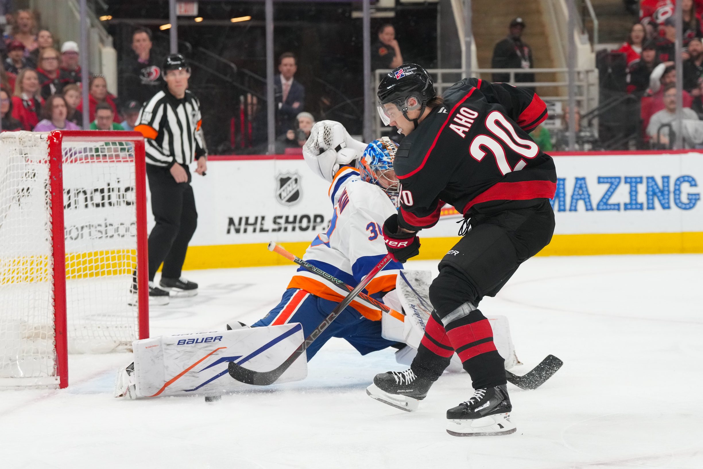 Apr 4, 2026; Raleigh, North Carolina, USA;  New York Islanders goaltender Ilya Sorokin (30) stops the scoring attempt by Carolina Hurricanes center Sebastian Aho (20) during the first period at Lenovo Center. Mandatory Credit: James Guillory-Imagn Images