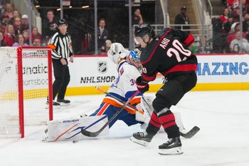 Apr 4, 2026; Raleigh, North Carolina, USA;  New York Islanders goaltender Ilya Sorokin (30) stops the scoring attempt by Carolina Hurricanes center Sebastian Aho (20) during the first period at Lenovo Center. Mandatory Credit: James Guillory-Imagn Images