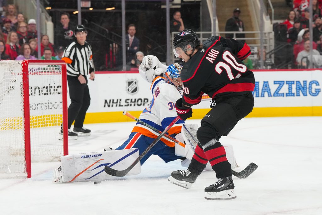 Apr 4, 2026; Raleigh, North Carolina, USA; New York Islanders goaltender Ilya Sorokin (30) stops the scoring attempt by Carolina Hurricanes center Sebastian Aho (20) during the first period at Lenovo Center. Mandatory Credit: James Guillory-Imagn Images