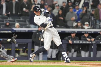 Apr 4, 2026; Bronx, New York, USA; New York Yankees right fielder Aaron Judge (99) hits an RBI single against the Miami Marlins during the sixth inning at Yankee Stadium. Mandatory Credit: Gregory Fisher-Imagn Images