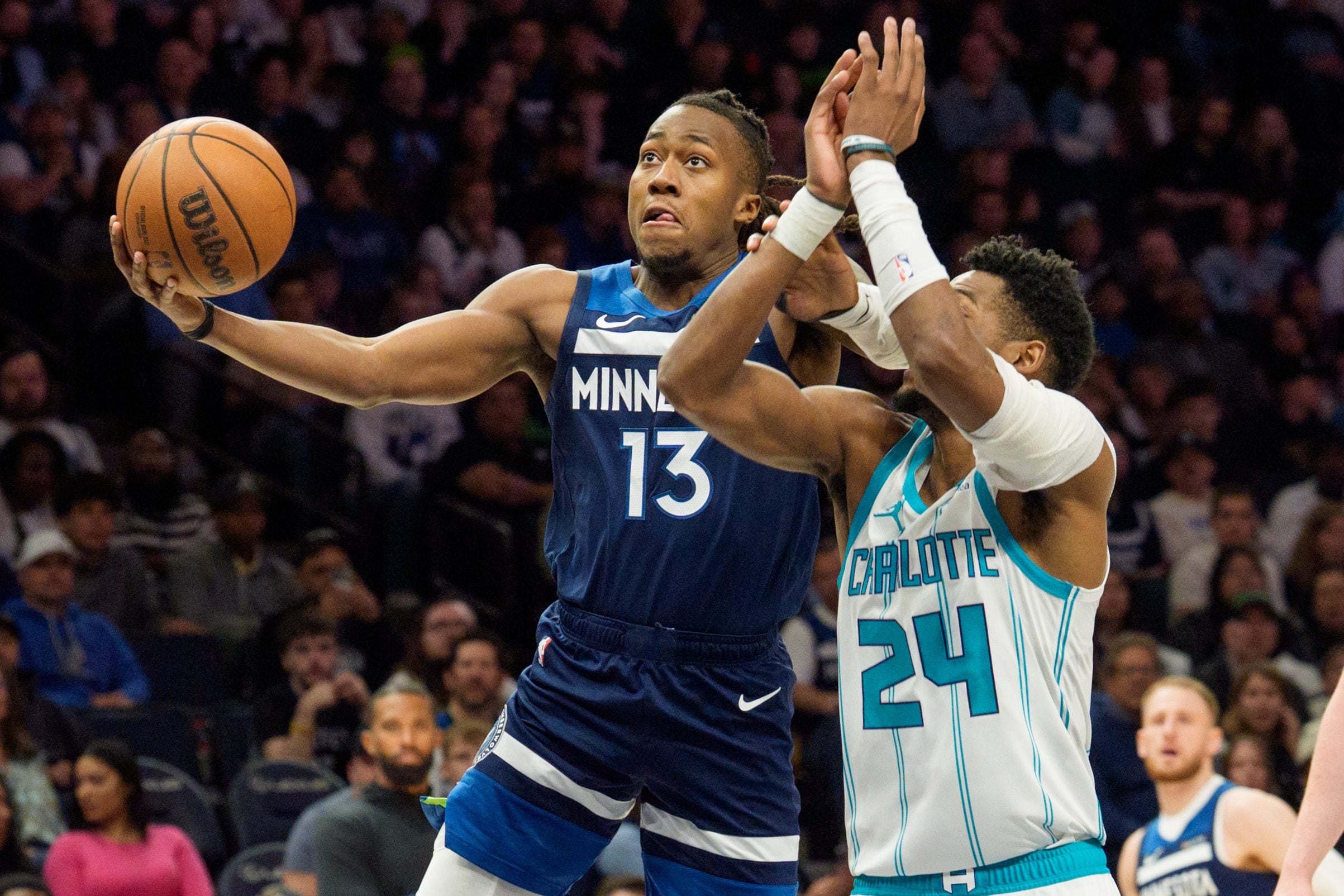 Apr 5, 2026; Minneapolis, Minnesota, USA; Minnesota Timberwolves guard Ayo Dosunmu (13) shoots as Charlotte Hornets forward Brandon Miller (24) defends in the second quarter at Target Center. Mandatory Credit: Matt Blewett-Imagn Images