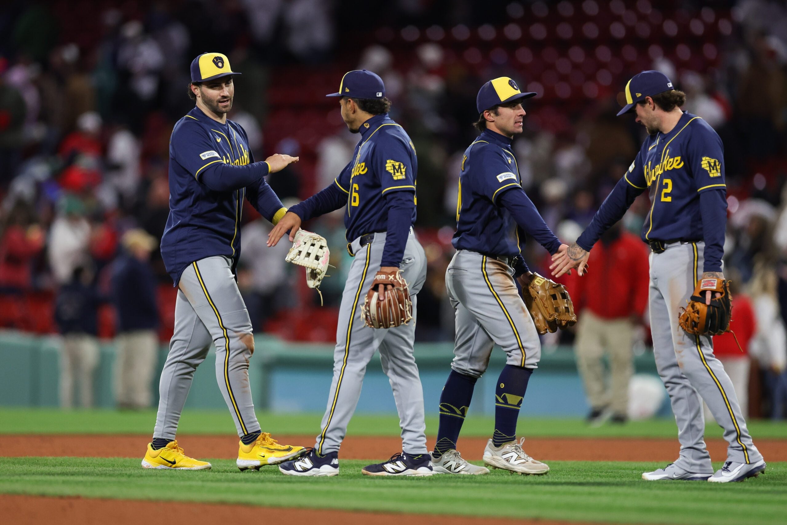 Apr 6, 2026; Boston, Massachusetts, USA; Milwaukee Brewers center fielder Garrett Mitchell (5) and Milwaukee Brewers right fielder Sal Frelick (10) celebrate after defeating the Boston Red Sox at Fenway Park. Mandatory Credit: Paul Rutherford-Imagn Images