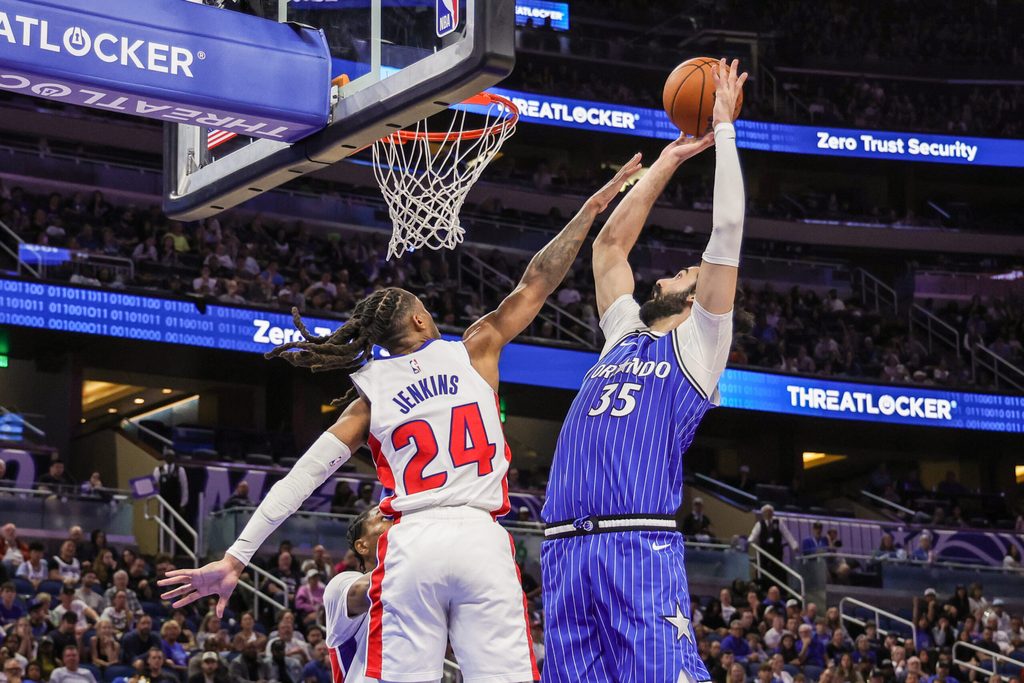 Apr 6, 2026; Orlando, Florida, USA; Orlando Magic center Goga Bitadze (35) goes to the basket against Detroit Pistons guard Daniss Jenkins (24) during the second half at Kia Center. Mandatory Credit: Mike Watters-Imagn Images
