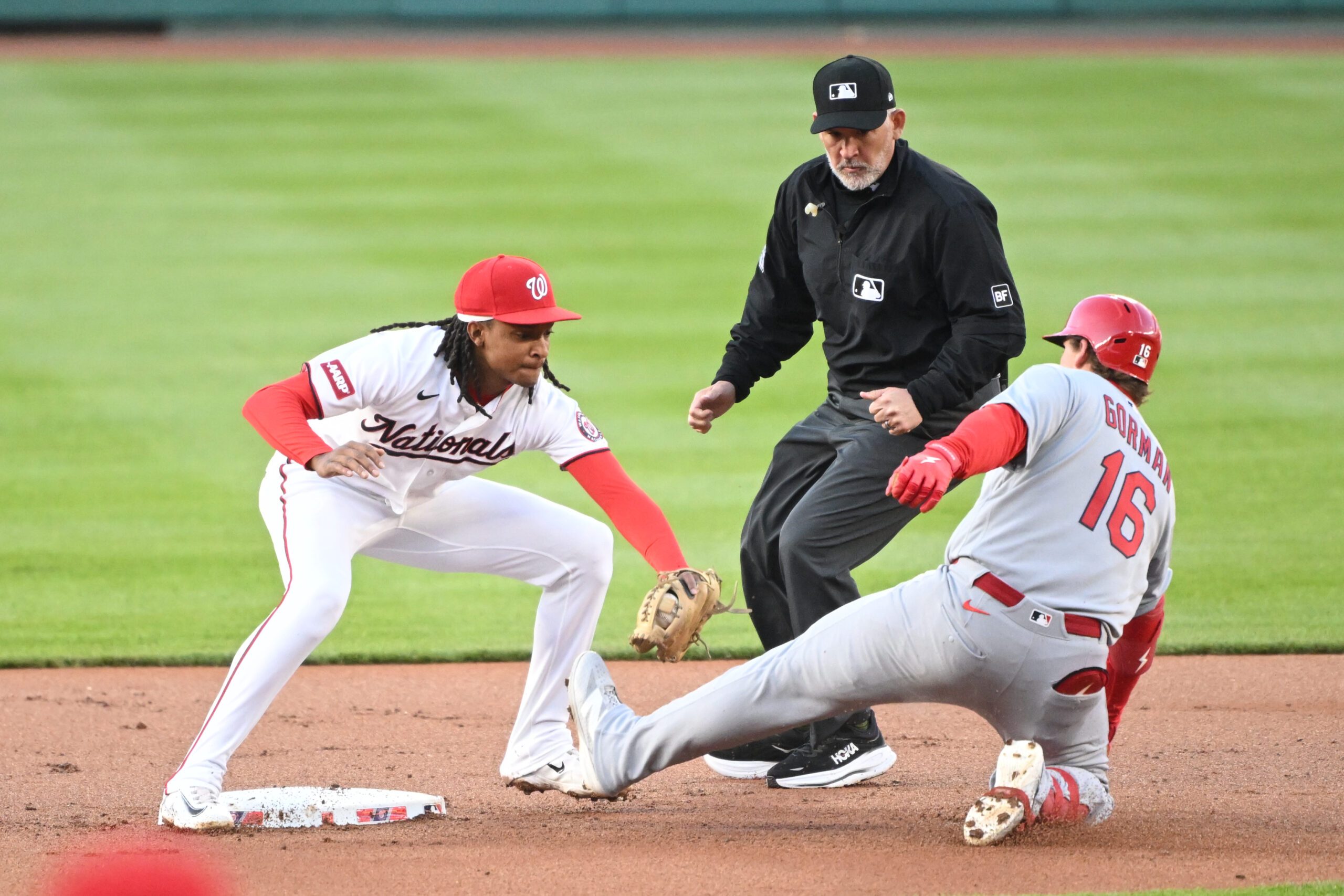 Apr 7, 2026; Washington, District of Columbia, USA; St. Louis Cardinals second baseman Nolan Gorman (16) is tagged out by Washington Nationals shortstop CJ Abrams (5) while trying to steal second base during the first inning at Nationals Park. Mandatory Credit: Rafael Suanes-Imagn Images