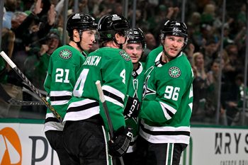 Apr 7, 2026; Dallas, Texas, USA; Dallas Stars defenseman Miro Heiskanen (4) and left wing Jason Robertson (21) and center Wyatt Johnston (53) and right wing Mikko Rantanen (96) celebrate after Johnston scores the game winning power-play goal against Calgary Flames goaltender Devin Cooley (not pictured) during the overtime period at the American Airlines Center. Mandatory Credit: Jerome Miron-Imagn Images