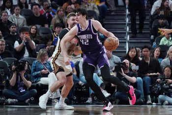 Apr 7, 2026; San Francisco, California, USA;  Sacramento Kings center Maxime Raynaud (42) dribbles against Golden State Warriors guard Pat Spencer (61) in the third quarter at Chase Center. Mandatory Credit: David Gonzales-Imagn Images