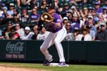 Apr 8, 2026; Denver, Colorado, USA; Colorado Rockies first baseman TJ Rumfield (7) fields the ball in the fifth inning against the Houston Astros delivers a pitch at Coors Field. Mandatory Credit: Ron Chenoy-Imagn Images