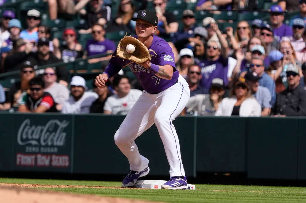 Apr 8, 2026; Denver, Colorado, USA; Colorado Rockies first baseman TJ Rumfield (7) fields the ball in the fifth inning against the Houston Astros delivers a pitch at Coors Field. Mandatory Credit: Ron Chenoy-Imagn Images
