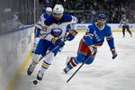 Apr 8, 2026; New York, New York, USA; Buffalo Sabres right wing Alex Tuch (89) attempts to control the puck defended by New York Rangers defenseman Matthew Robertson (29) during the first period at Madison Square Garden. Mandatory Credit: Dennis Schneidler-Imagn Images