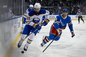 Apr 8, 2026; New York, New York, USA; Buffalo Sabres right wing Alex Tuch (89) attempts to control the puck defended by New York Rangers defenseman Matthew Robertson (29) during the first period at Madison Square Garden. Mandatory Credit: Dennis Schneidler-Imagn Images