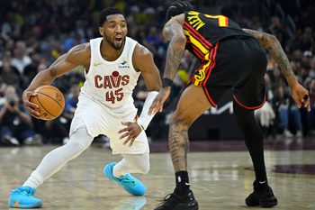 Apr 8, 2026; Cleveland, Ohio, USA; Cleveland Cavaliers guard Donovan Mitchell (45) dribbles defended by Atlanta Hawks guard Nickeil Alexander-Walker (7) in the third quarter at Rocket Arena. Mandatory Credit: David Richard-Imagn Images