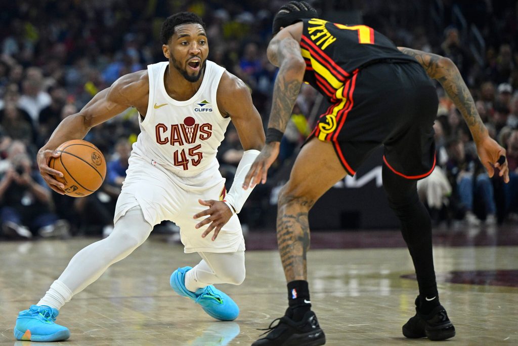 Apr 8, 2026; Cleveland, Ohio, USA; Cleveland Cavaliers guard Donovan Mitchell (45) dribbles defended by Atlanta Hawks guard Nickeil Alexander-Walker (7) in the third quarter at Rocket Arena. Mandatory Credit: David Richard-Imagn Images