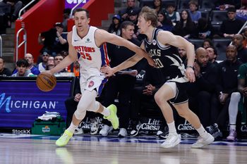 Apr 08, 2026; Detroit, Michigan, USA; Detroit Pistons forward Duncan Robinson (55) dribbles defended by Milwaukee Bucks guard AJ Green (20) in the second half at Little Caesars Arena. Mandatory Credit: Rick Osentoski-Imagn Images