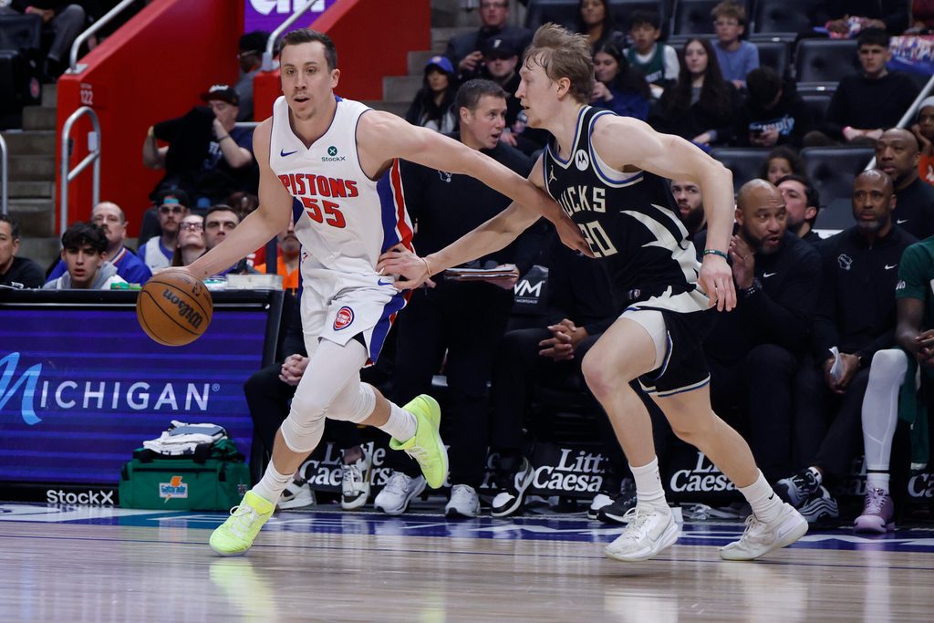 Apr 08, 2026; Detroit, Michigan, USA; Detroit Pistons forward Duncan Robinson (55) dribbles defended by Milwaukee Bucks guard AJ Green (20) in the second half at Little Caesars Arena. Mandatory Credit: Rick Osentoski-Imagn Images