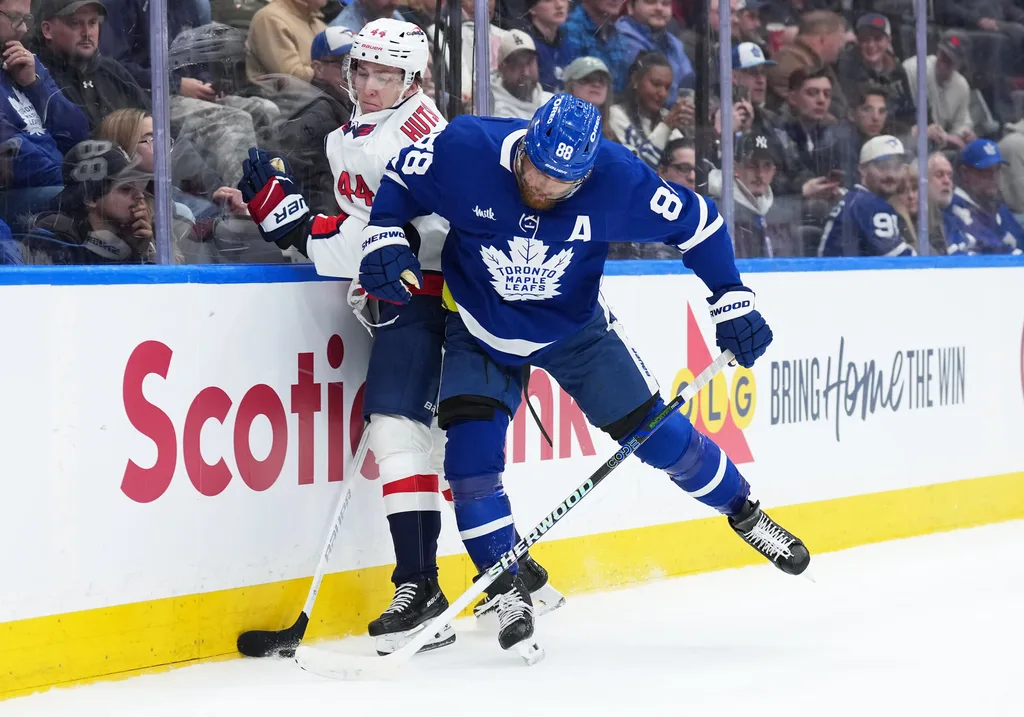 Apr 8, 2026; Toronto, Ontario, CAN; Washington Capitals defenceman Cole Hutson (44) battles along the boards with Toronto Maple Leafs right wing William Nylander (88) during the third period at Scotiabank Arena. Mandatory Credit: Nick Turchiaro-Imagn Images