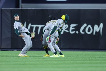 Apr 8, 2026; Bronx, New York, USA;  Athletics outfielders Athletics left fielder Tyler Soderstrom (21), Denzel Clarke (1) and Lawrence Butler (4) celebrate after defeating the New York Yankees 3-2 at Yankee Stadium. Mandatory Credit: Wendell Cruz-Imagn Images