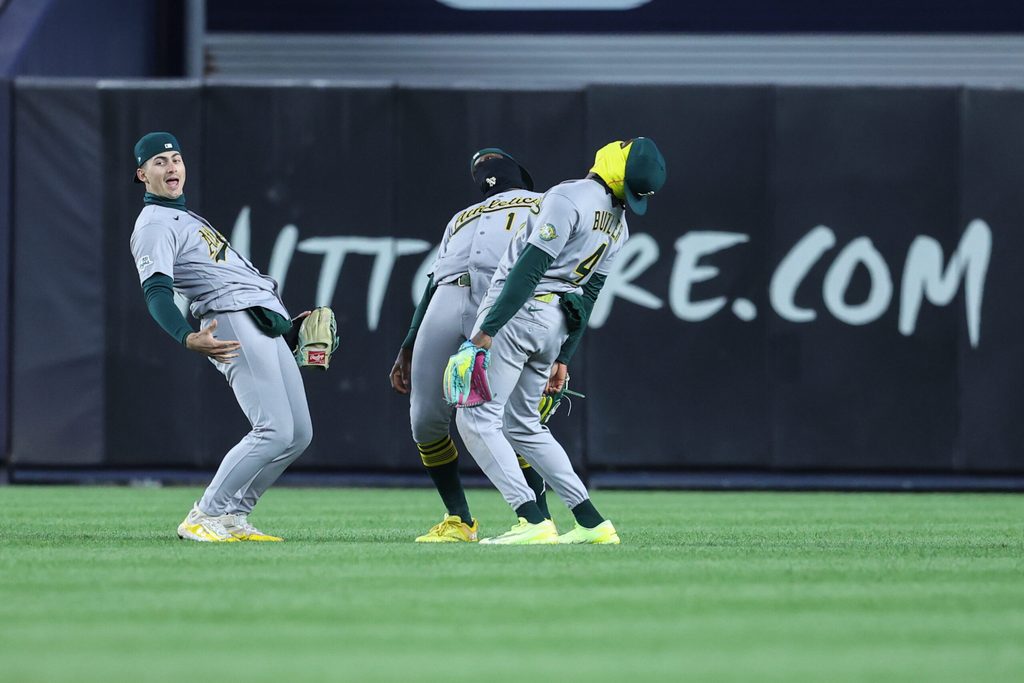 Apr 8, 2026; Bronx, New York, USA; Athletics outfielders Athletics left fielder Tyler Soderstrom (21), Denzel Clarke (1) and Lawrence Butler (4) celebrate after defeating the New York Yankees 3-2 at Yankee Stadium. Mandatory Credit: Wendell Cruz-Imagn Images
