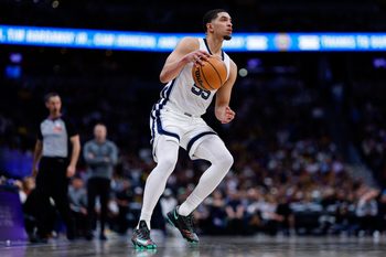 Apr 8, 2026; Denver, Colorado, USA; Memphis Grizzlies guard Lucas Williamson (55) controls the ball in the third quarter against the Denver Nuggets at Ball Arena. Mandatory Credit: Isaiah J. Downing-Imagn Images