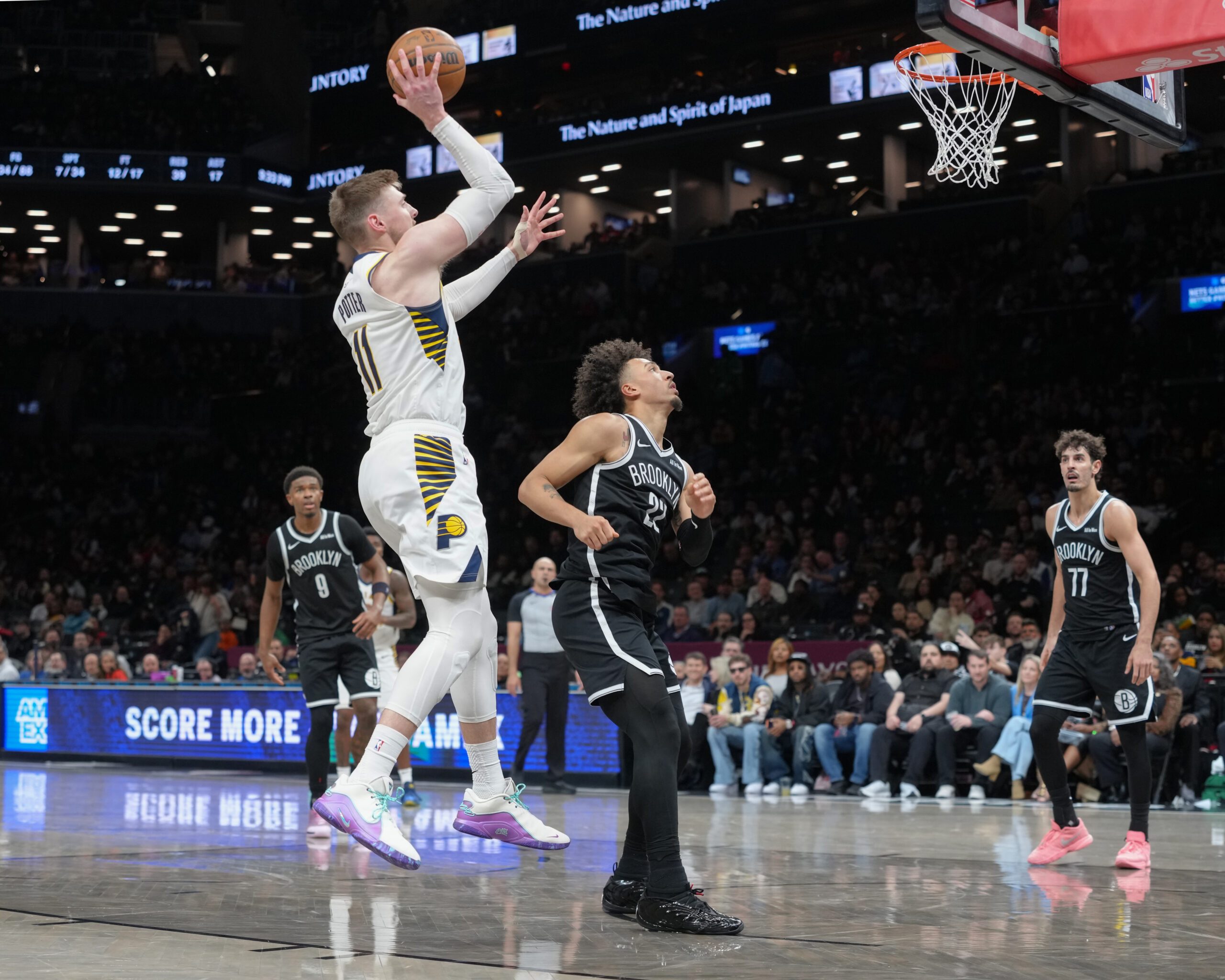 Apr 9, 2026; Brooklyn, New York, USA; Indiana Pacers center Micah Potter (11) shoots the ball against Brooklyn Nets forward Jalen Wilson (22) during the second half at Barclays Center. Mandatory Credit: Gregory Fisher-Imagn Images