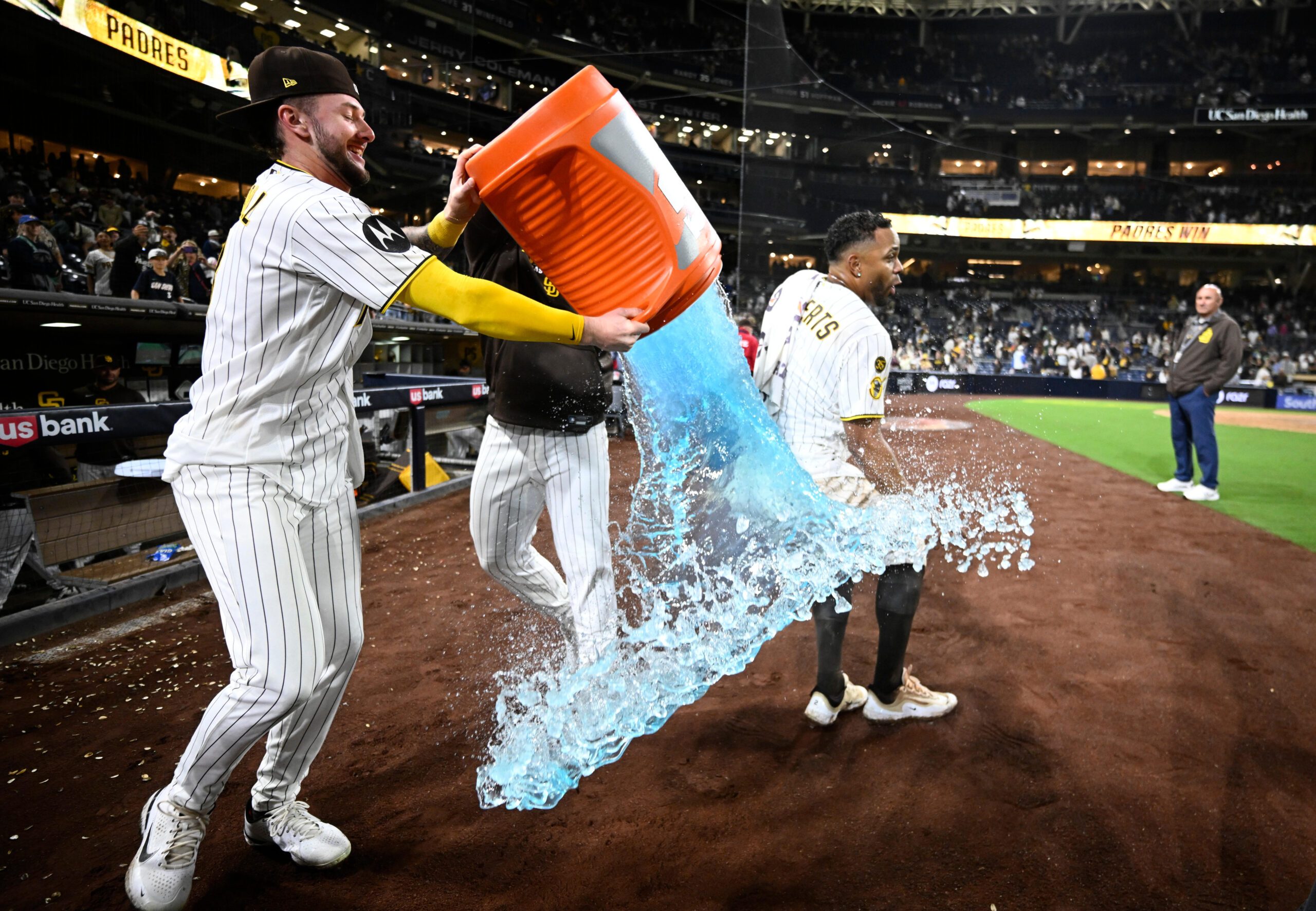 Apr 9, 2026; San Diego, California, USA; San Diego Padres center fielder Jackson Merrill (3) attempts to pour the contents of a beverage cooler over shortstop Xander Bogaerts (2) after Bogaerts hit a walk-off grand slam home run in the twelfth inning against the Colorado Rockies at Petco Park. Mandatory Credit: Denis Poroy-Imagn Images