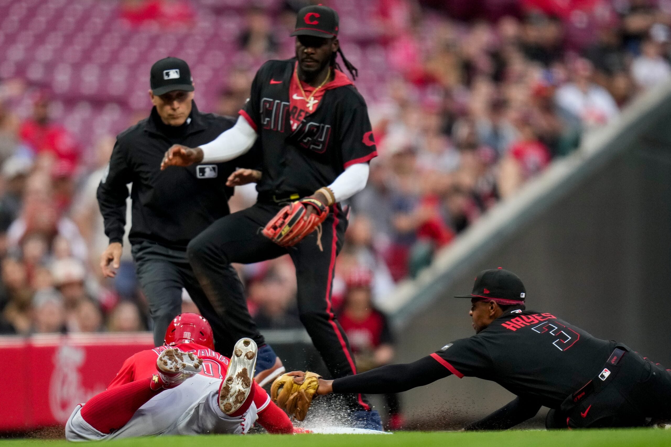 Cincinnati Reds third baseman Ke'Bryan Hayes (3) dives to third base attempting tag out Los Angeles Angels third baseman Yoán Moncada (10) in the second inning of the MLB Interleague game between the Cincinnati Reds and the Los Angeles Angels at Great American Ball Park in downtown Cincinnati on Friday, April 10, 2026.