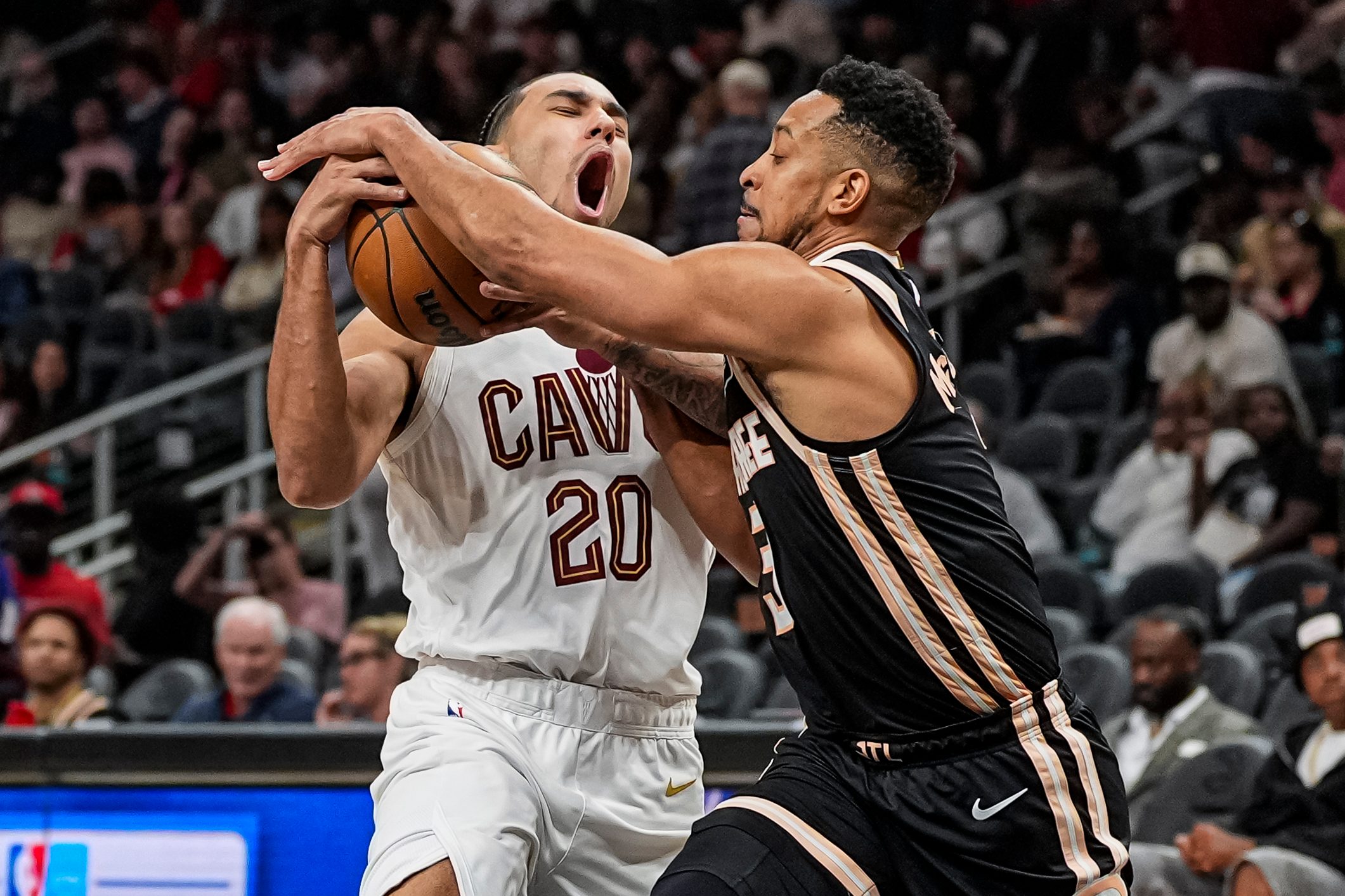 Apr 10, 2026; Atlanta, Georgia, USA; Cleveland Cavaliers guard Jaylon Tyson (20) tries to drive to the basket against Atlanta Hawks guard CJ McCollum (3) during the second half at State Farm Arena. Mandatory Credit: Dale Zanine-Imagn Images