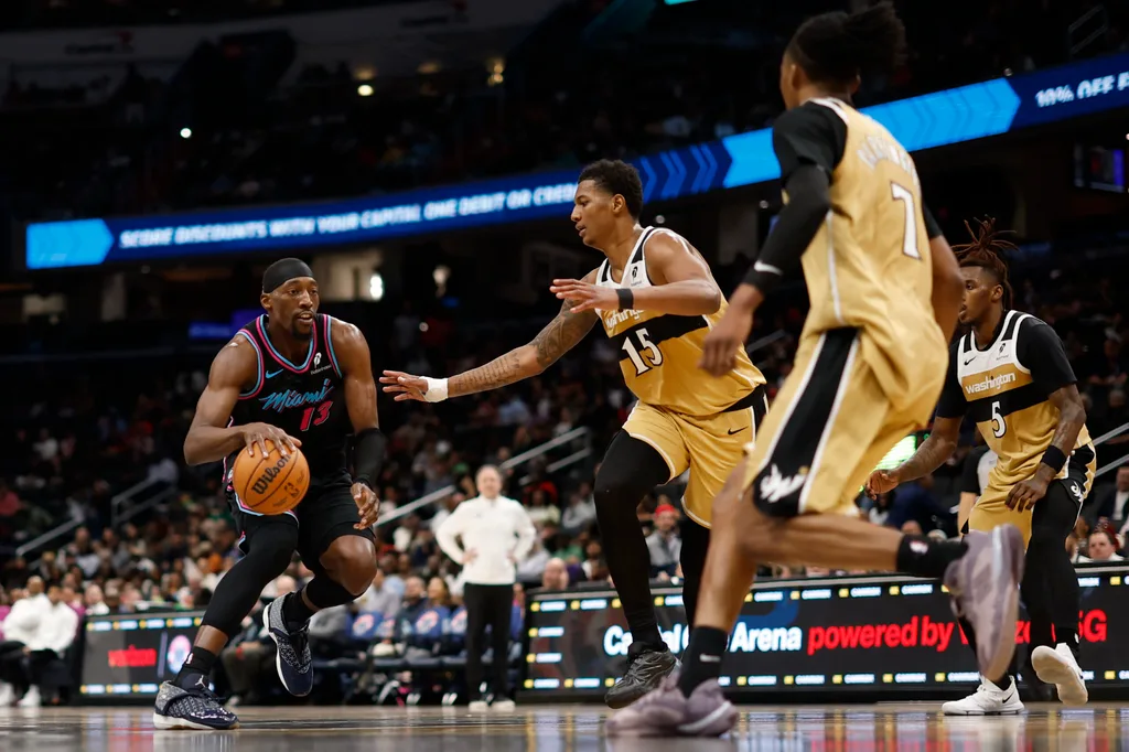 Apr 10, 2026; Washington, District of Columbia, USA; Miami Heat center Bam Adebayo (13) drives to the basket as Washington Wizards forward Julian Reese (15) defends in the first half at Capital One Arena. Mandatory Credit: Geoff Burke-Imagn Images