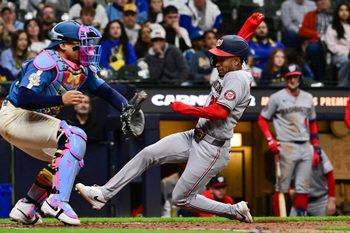 Apr 10, 2026; Milwaukee, Wisconsin, USA; Washington Nationals shortstop Nasim Nunez (26) scores on a squeeze bunt as Milwaukee Brewers catcher William Contreras (24) waits for the ball in the ninth inning at American Family Field. Mandatory Credit: Benny Sieu-Imagn Images