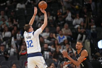 Apr 10, 2026; San Antonio, Texas, USA;  Dallas Mavericks forward Cooper Flagg (32) shoots over San Antonio Spurs forward Victor Wembanyama (1) during the second half at Frost Bank Center. Mandatory Credit: Scott Wachter-Imagn Images
