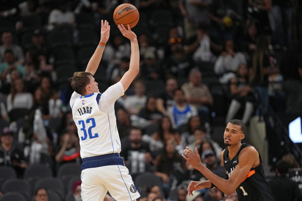 Apr 10, 2026; San Antonio, Texas, USA; Dallas Mavericks forward Cooper Flagg (32) shoots over San Antonio Spurs forward Victor Wembanyama (1) during the second half at Frost Bank Center. Mandatory Credit: Scott Wachter-Imagn Images