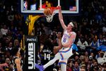 Apr 10, 2026; Denver, Colorado, USA; Oklahoma City Thunder center Branden Carlson (15) dunks the ball over Denver Nuggets forward Daron Holmes II (14) in the second half at Ball Arena. Mandatory Credit: Ron Chenoy-Imagn Images