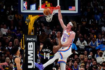 Apr 10, 2026; Denver, Colorado, USA; Oklahoma City Thunder center Branden Carlson (15) dunks the ball over Denver Nuggets forward Daron Holmes II (14) in the second half at Ball Arena. Mandatory Credit: Ron Chenoy-Imagn Images