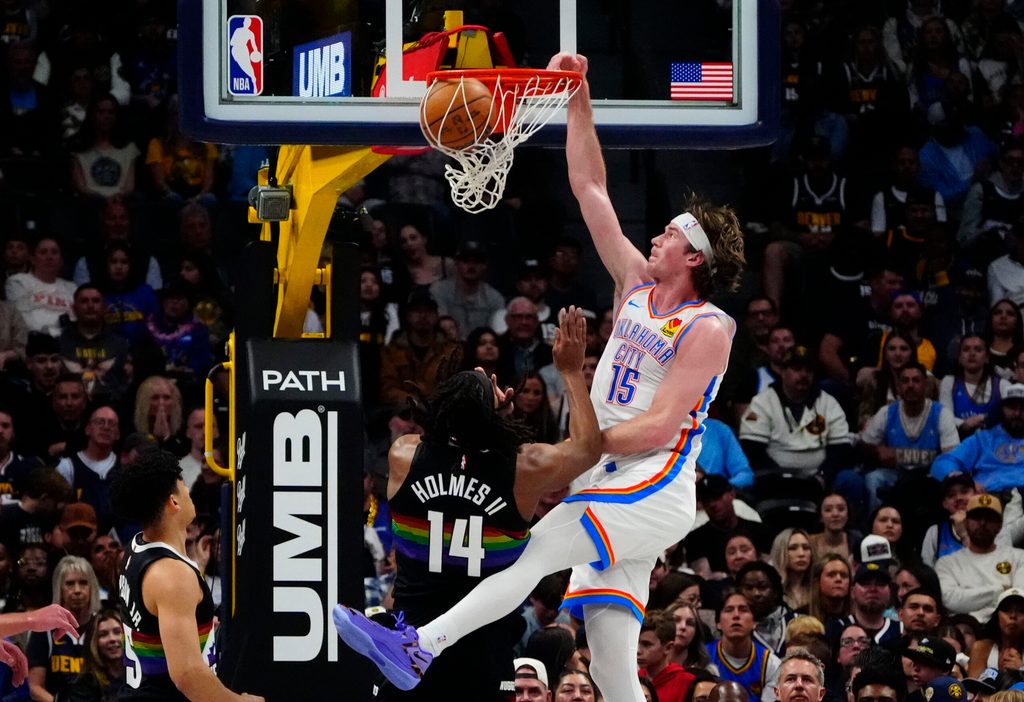 Apr 10, 2026; Denver, Colorado, USA; Oklahoma City Thunder center Branden Carlson (15) dunks the ball over Denver Nuggets forward Daron Holmes II (14) in the second half at Ball Arena. Mandatory Credit: Ron Chenoy-Imagn Images