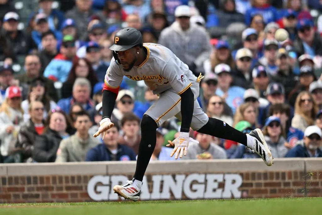 Apr 11, 2026; Chicago, Illinois, USA; Pittsburgh Pirates center fielder Oneil Cruz (15) slides into home plate to score against the Chicago Cubs during the third inning at Wrigley Field. Mandatory Credit: Patrick Gorski-Imagn Images