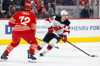 Apr 11, 2026; Detroit, Michigan, USA;  New Jersey Devils center Jack Hughes (86) skates with the puck defended by Detroit Red Wings defenseman Justin Faulk (72) in the first period at Little Caesars Arena. Mandatory Credit: Rick Osentoski-Imagn Images