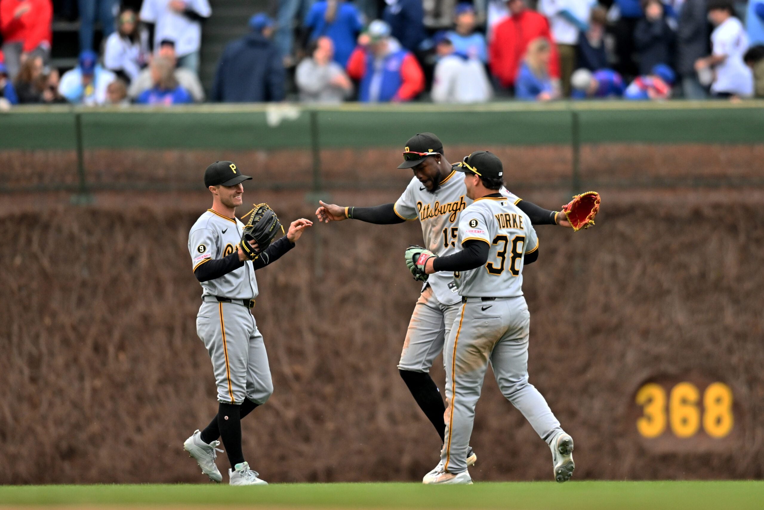 Apr 11, 2026; Chicago, Illinois, USA; Pittsburgh Pirates outfielders Jake Mangum, O’Neil Cruz, and Ryan O’Hearn (38) celebrate their victory over the Chicago Cubs at Wrigley Field. Mandatory Credit: Patrick Gorski-Imagn Images