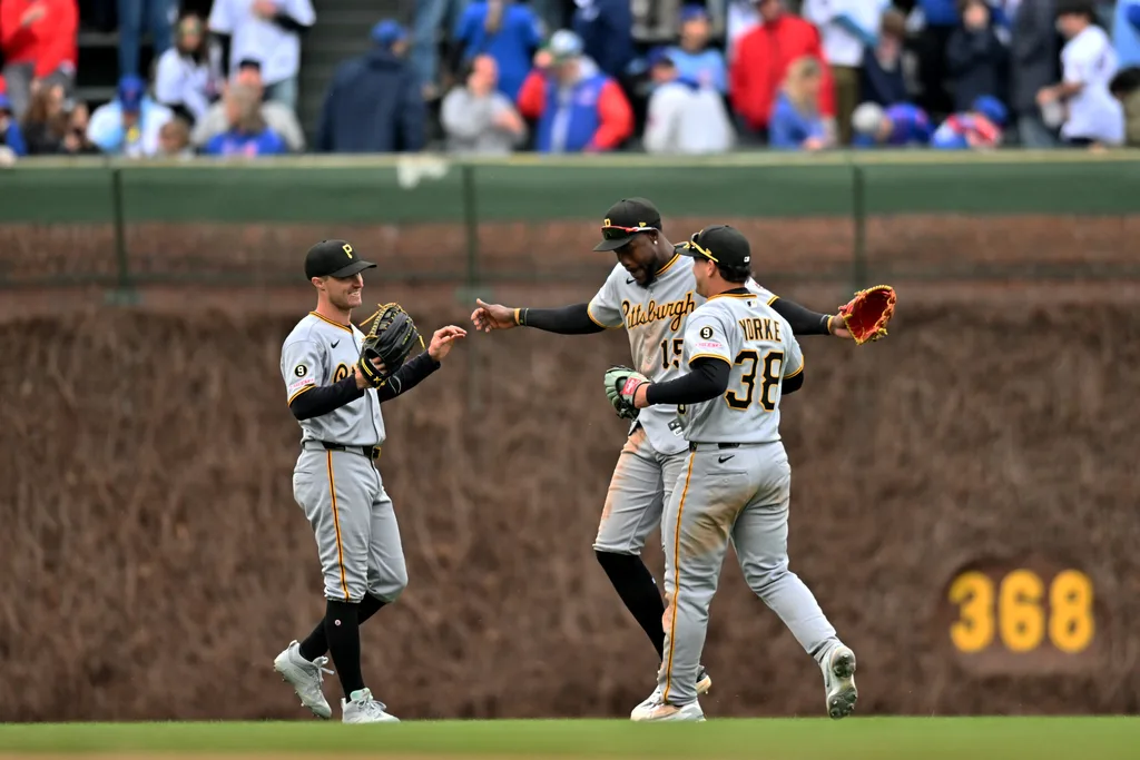 Apr 11, 2026; Chicago, Illinois, USA; Pittsburgh Pirates outfielders Jake Mangum, O’Neil Cruz, and Ryan O’Hearn (38) celebrate their victory over the Chicago Cubs at Wrigley Field. Mandatory Credit: Patrick Gorski-Imagn Images