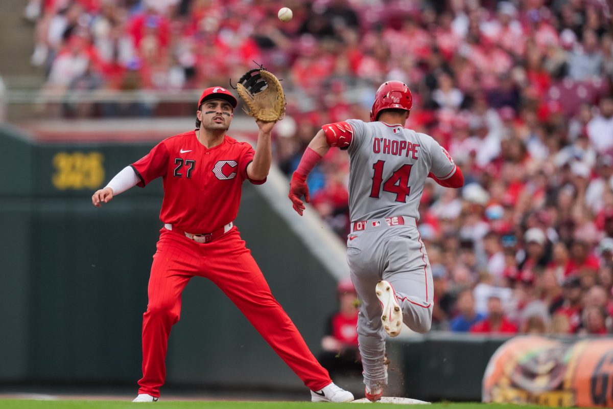 Apr 11, 2026; Cincinnati, Ohio, USA;  Cincinnati Reds third baseman Sal Stewart (27) fields the ball as Los Angeles Angels catcher Logan O'Hoppe (14) attempts to run to first base after striking out in the eighth inning at Great American Ball Park. Logan O’Hoppe was called out for batter interference. Mandatory Credit: Aaron Doster-Imagn Images