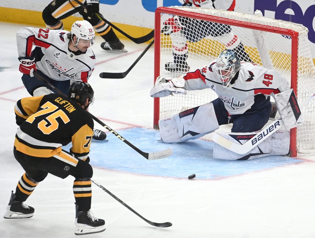 Apr 11, 2026; Pittsburgh, Pennsylvania, USA; Pittsburgh Penguins defenseman Connor Clifton (75) pressures Washington Capitals goalie Logan Thompson (48) as left wing Brandon Duhaime (22) takes part in the play during the first period at PPG Paints Arena. Mandatory Credit: Philip G. Pavely-Imagn Images