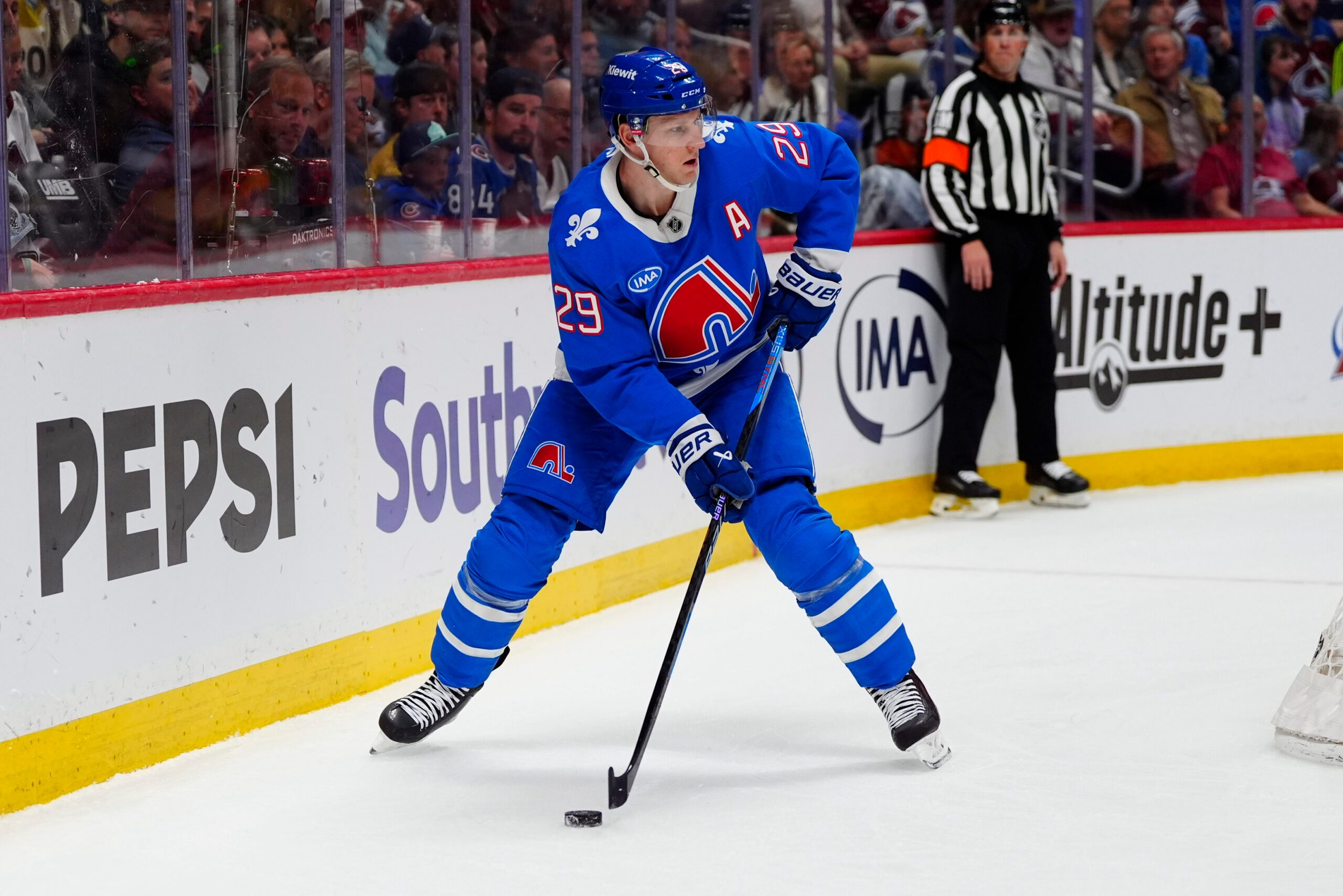Apr 11, 2026; Denver, Colorado, USA; Colorado Avalanche center Nathan MacKinnon (29) controls the puck in the second period against the Vegas Golden Knights  at Ball Arena. Mandatory Credit: Ron Chenoy-Imagn Images