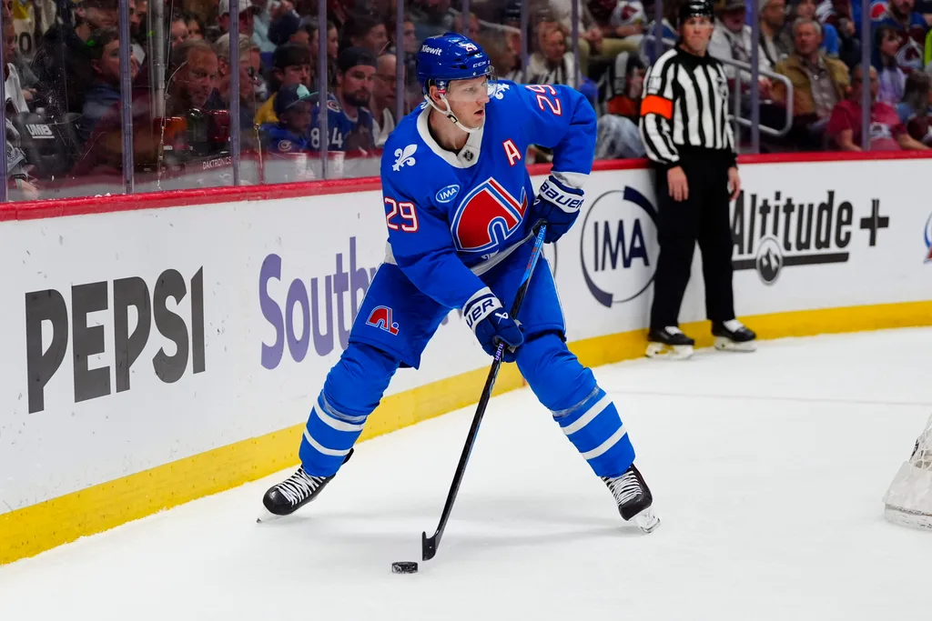 Apr 11, 2026; Denver, Colorado, USA; Colorado Avalanche center Nathan MacKinnon (29) controls the puck in the second period against the Vegas Golden Knights at Ball Arena. Mandatory Credit: Ron Chenoy-Imagn Images