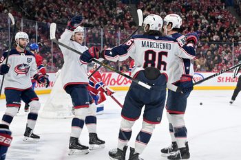 Apr 11, 2026; Montreal, Quebec, CAN; Columbus Blue Jackets forward Charlie Coyle (3) celebrates with teammates after scoring a goal against Montreal Canadiens goalie Jakub Dobes (75) during the third period at the Bell Centre. Mandatory Credit: Eric Bolte-Imagn Images