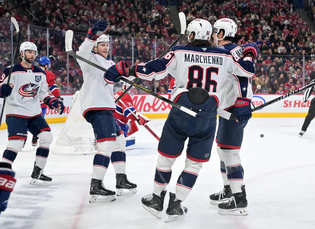 Apr 11, 2026; Montreal, Quebec, CAN; Columbus Blue Jackets forward Charlie Coyle (3) celebrates with teammates after scoring a goal against Montreal Canadiens goalie Jakub Dobes (75) during the third period at the Bell Centre. Mandatory Credit: Eric Bolte-Imagn Images