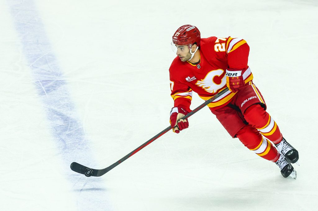 Apr 12, 2026; Calgary, Alberta, CAN; Calgary Flames right wing Matt Coronato (27) controls the puck against the Utah Mammoth during the first period at Scotiabank Saddledome. Mandatory Credit: Sergei Belski-USA TODAY Sports