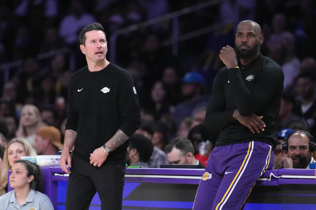 Apr 12, 2026; Los Angeles, California; Los Angeles Lakers head coach JJ Redick (left) and forward LeBron James (23) watch against the Utah Jazz in the first half at Crypto.com Arena. Mandatory Credit: Kirby Lee-Imagn Images