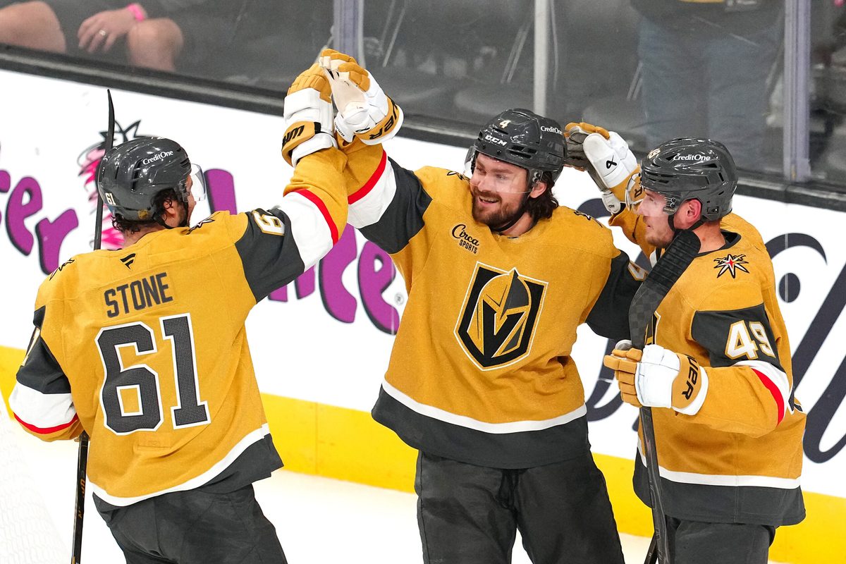 Apr 13, 2026; Las Vegas, Nevada, USA; Vegas Golden Knights defenseman Rasmus Andersson (4) celebrates with right wing Mark Stone (61) and left wing Ivan Barbashev (49) after scoring a goal against the Winnipeg Jets during the third period at T-Mobile Arena. Mandatory Credit: Stephen R. Sylvanie-Imagn Images