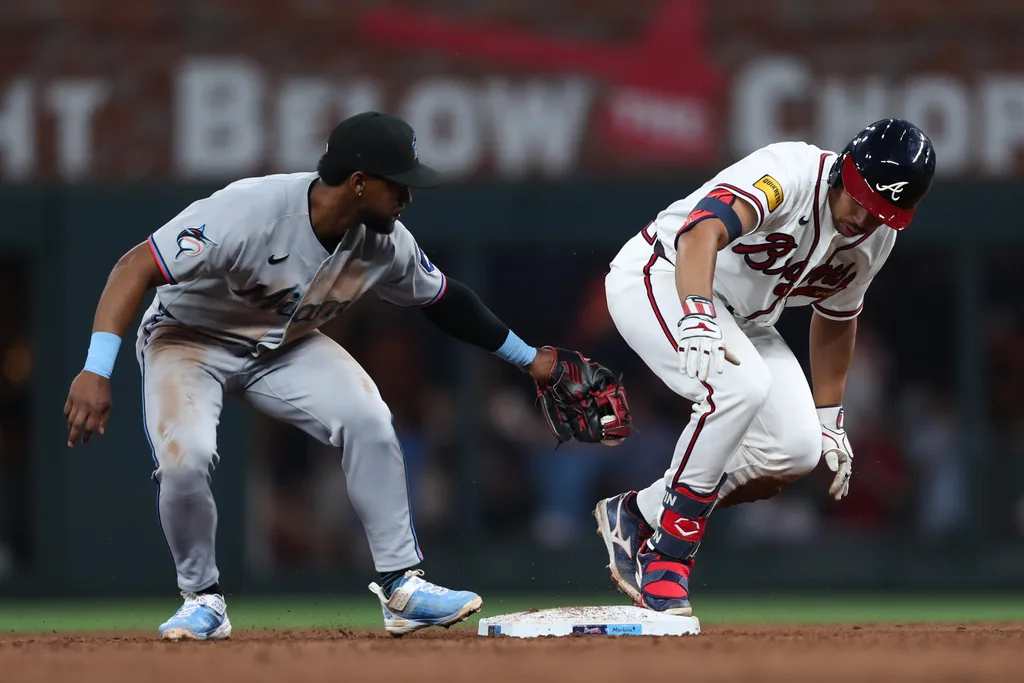 Apr 14, 2026; Cumberland, Georgia, USA; Atlanta Braves catcher Drake Baldwin (30) is safe on second base next to Miami Marlins shortstop Xavier Edwards (9) in the third inning at Truist Park. Mandatory Credit: Mady Mertens-Imagn Images