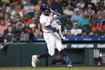Apr 14, 2026; Houston, Texas, USA; Houston Astros shortstop Carlos Correa (1) hits a single during the seventh inning against the Colorado Rockies at Daikin Park. Mandatory Credit: Troy Taormina-Imagn Images