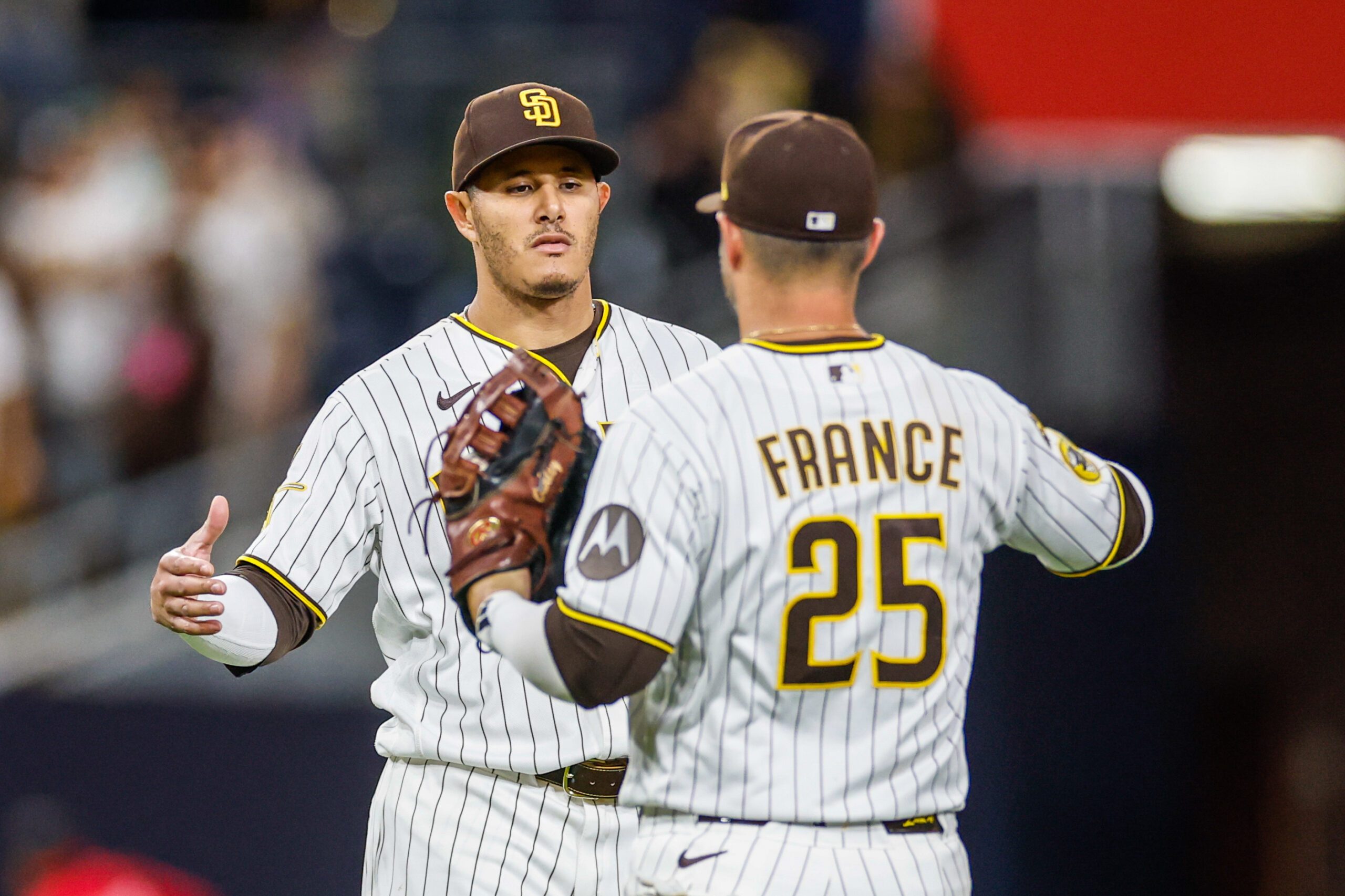 Apr 14, 2026; San Diego, California, USA; San Diego Padres third baseman Manny Machado (13) celebrates with first baseman Ty France (25) after defeating the Seattle Mariners at Petco Park. Mandatory Credit: David Frerker-Imagn Images